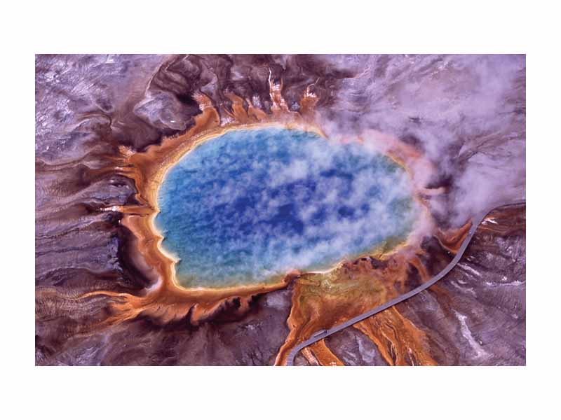 The orange ring surrounding Grand Prismatic Spring is due to carotenoid molecules, produced by huge mats of algae and bacteria.